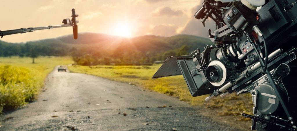 Behind the scenes making of movie and TV commercial. Camera of movie and video production. Film Crew. B-roll, and crew team in outdoor nature background.