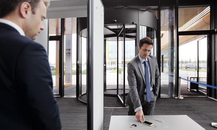 Security guard controlling indoor entrance gate
