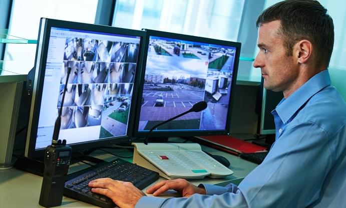 Security worker during monitoring. Video surveillance system.